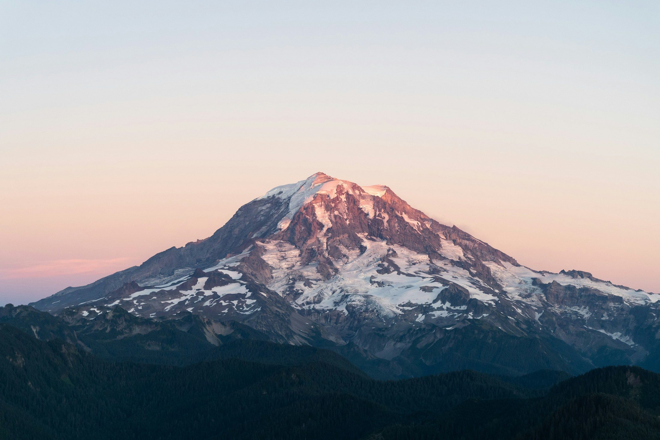 Alpenglow lighting the summit of Mount Rainier at sunrise